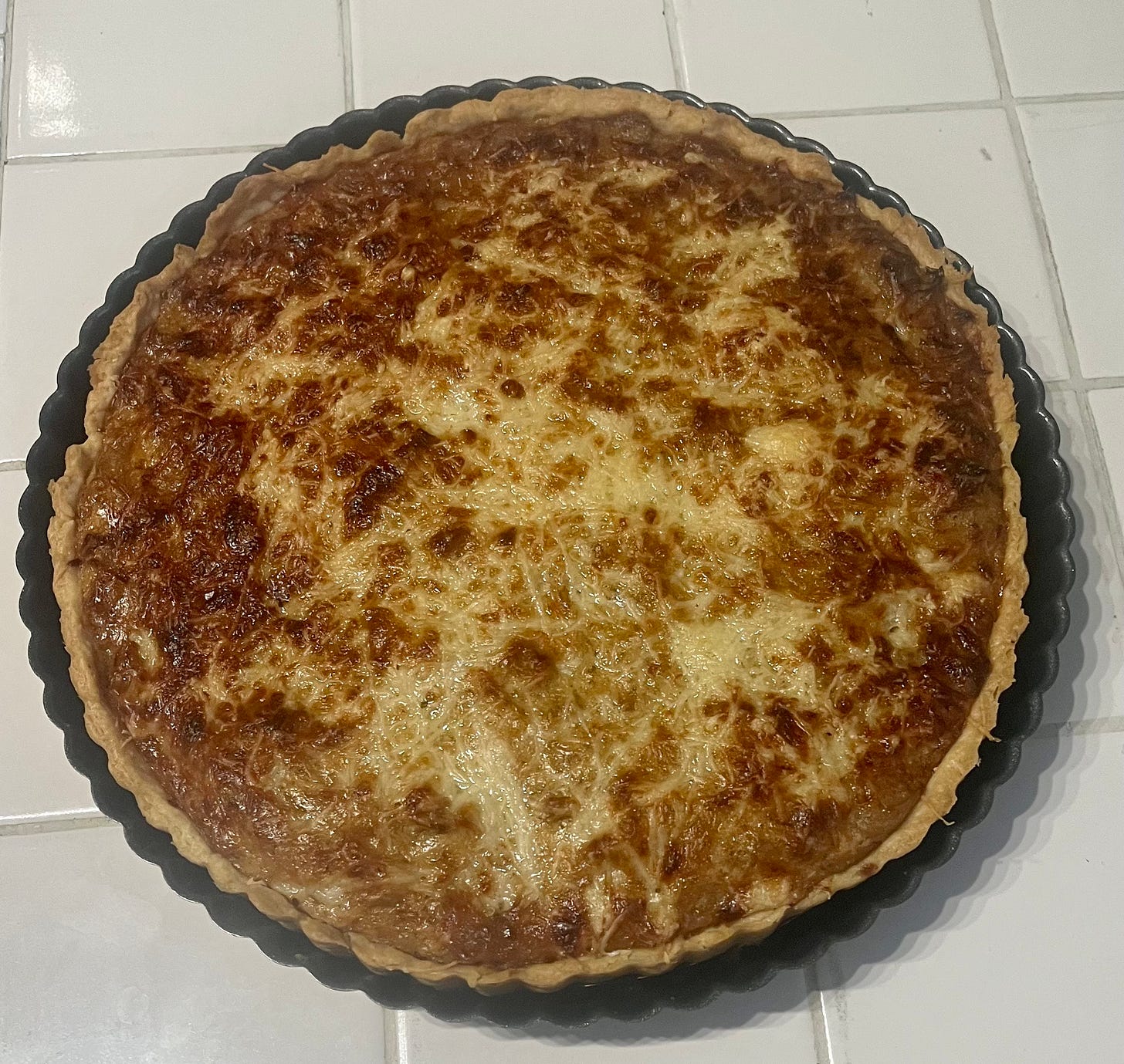 A bubbly, baked onion and gruyere tart
