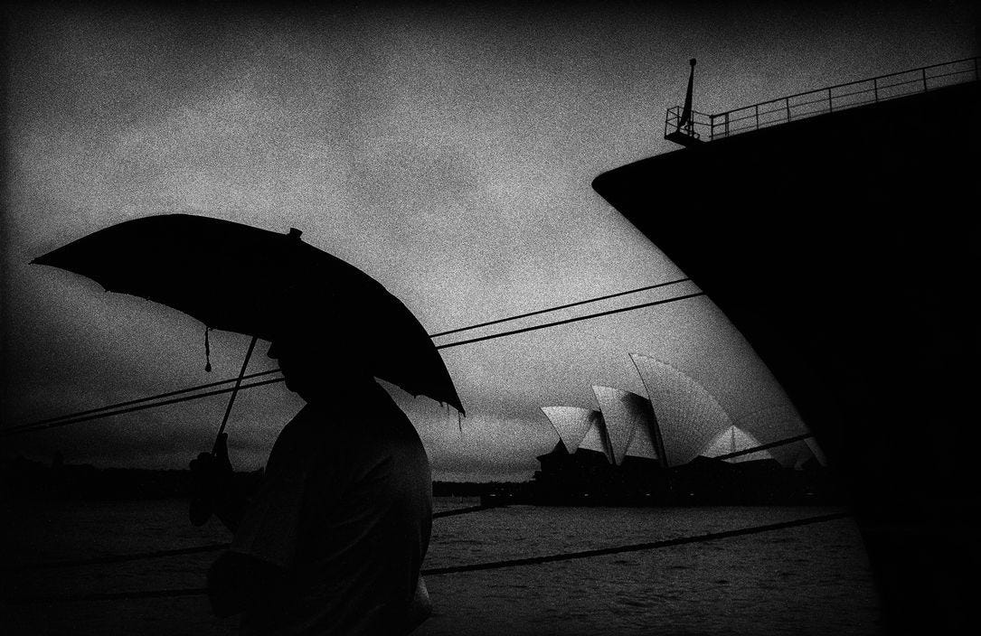 A man stands in the rain at the overseas passenger terminal on Sydney harbour, 1999. Trent Parke