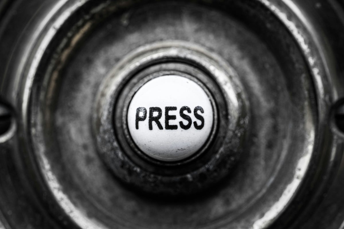 Image of a Doorbell, with the word “PRESS”.