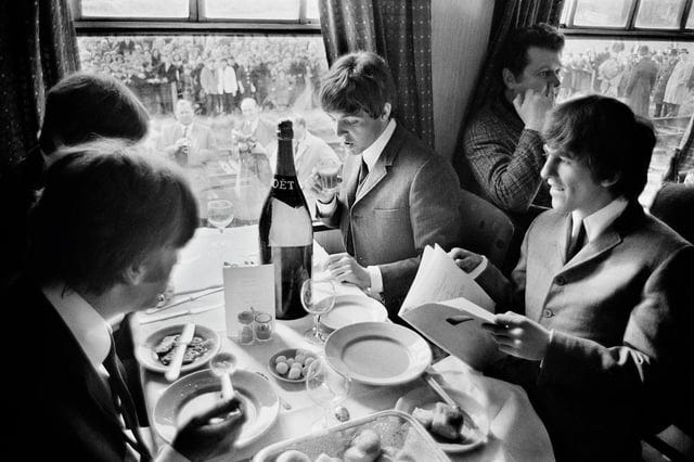 r/TheBeatles - The Beatles eat a meal on the train, while thousands of fans line the route. 1964