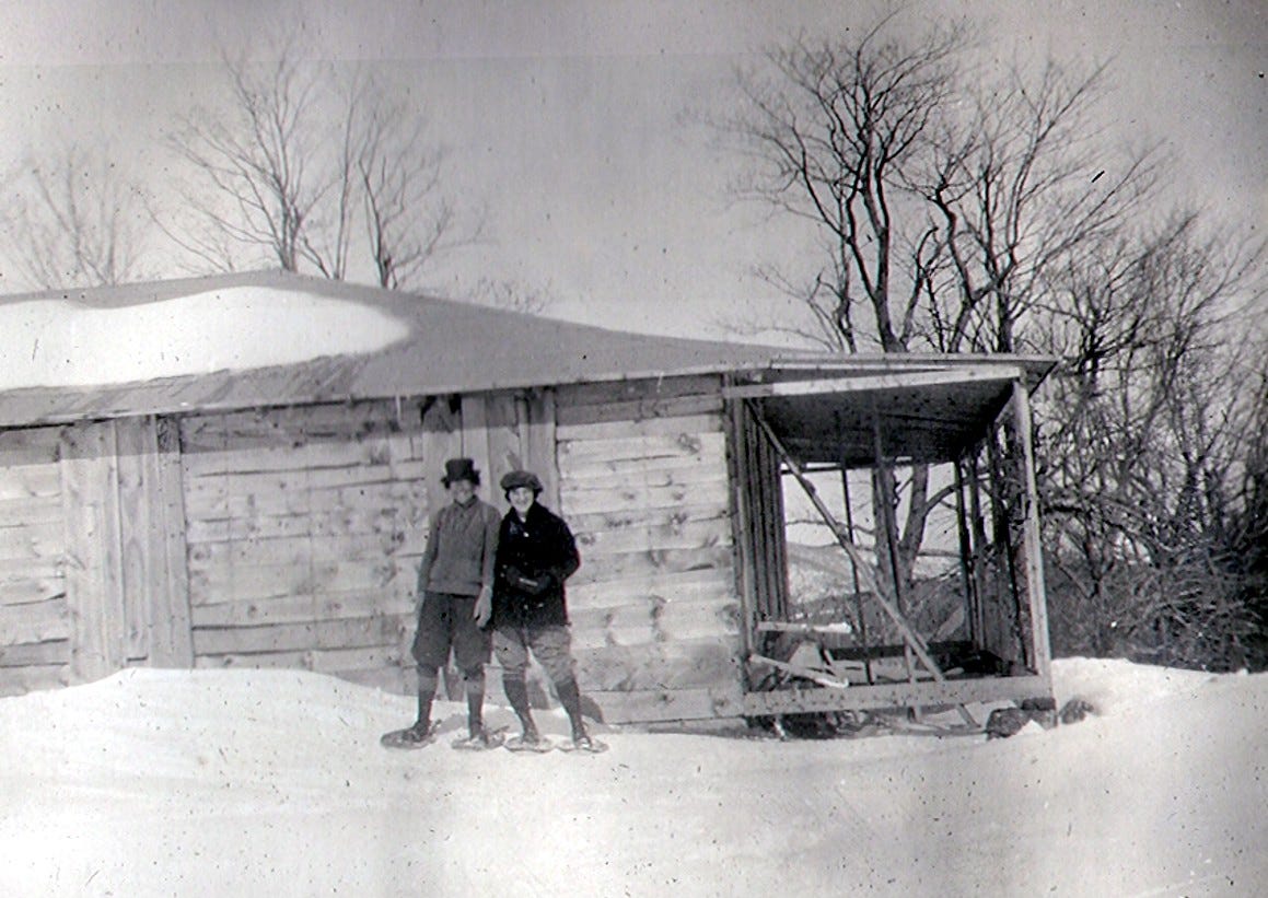 Couple in snowshoes in front of Wapack Lodge