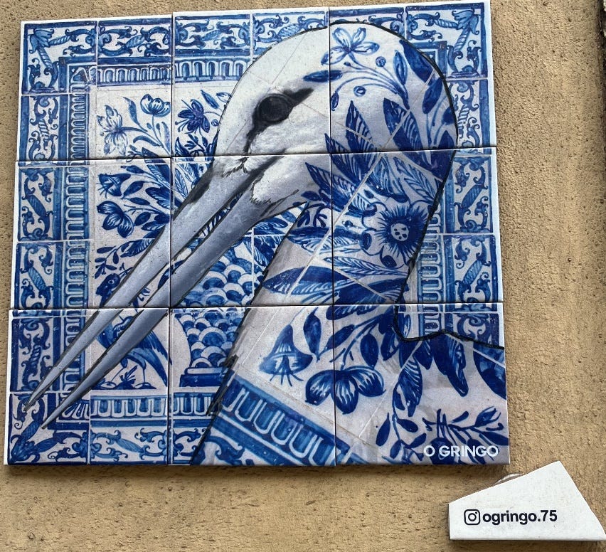 A tile with a bird's head painted on it