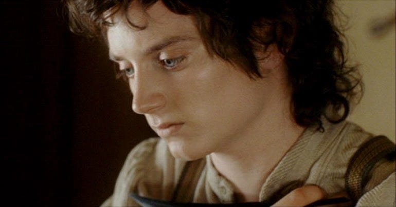 Frodo clutching his shoulder where he was stabbed
