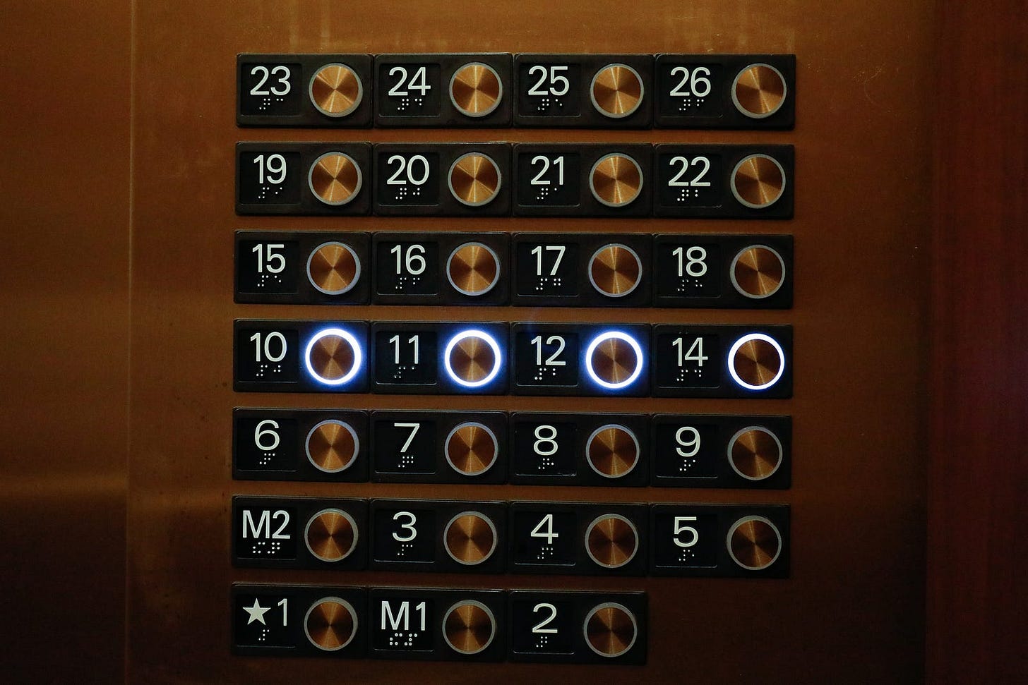 An elevator with a missing 13th floor button.