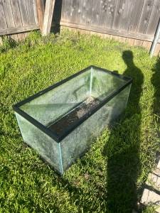 Another Craigslist aquarium listing featuring the tank in some grass next to a large human shadow.