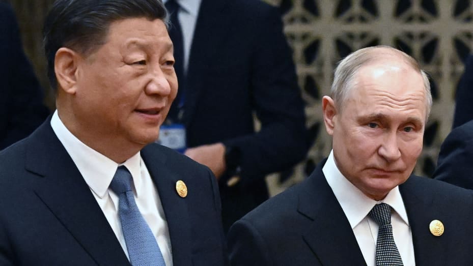 This pool photograph distributed by Russian state owned agency Sputnik shows Russia's President Vladimir Putin (R) and China's President Xi Jinping heading to a group photo session during the third Belt and Road Forum for International Cooperation at the Great Hall of the People in Beijing on October 18, 2023. (Photo by Grigory SYSOYEV / POOL / AFP) (Photo by GRIGORY SYSOYEV/POOL/AFP via Getty Images)