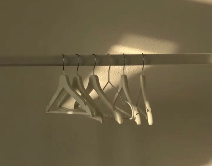 This may contain: four pairs of clothes hang on a rack in the sun, with one hanging off to the side