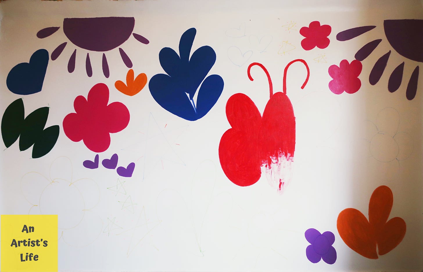 Colourful paintings of flowers, sun, leaves and butterfly on a white wall