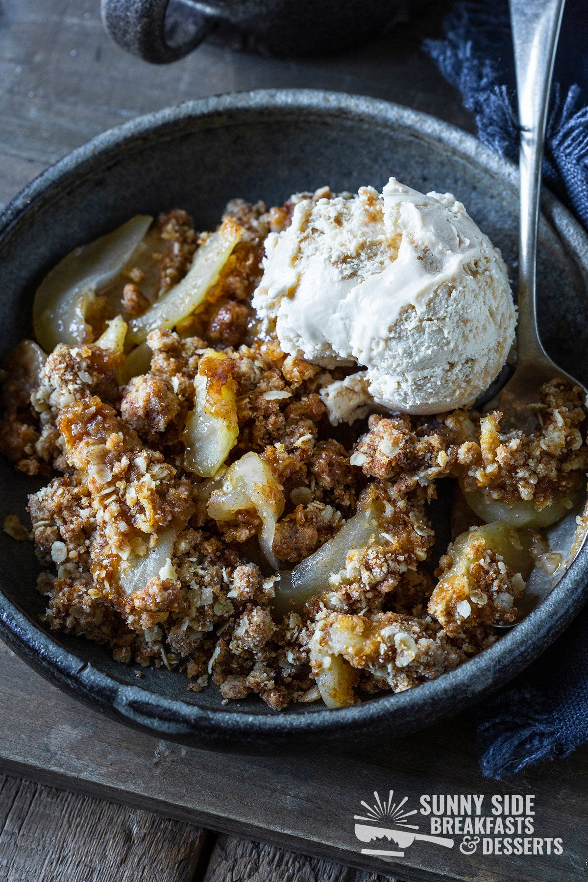 Bowl with apple crisp and ice cream.