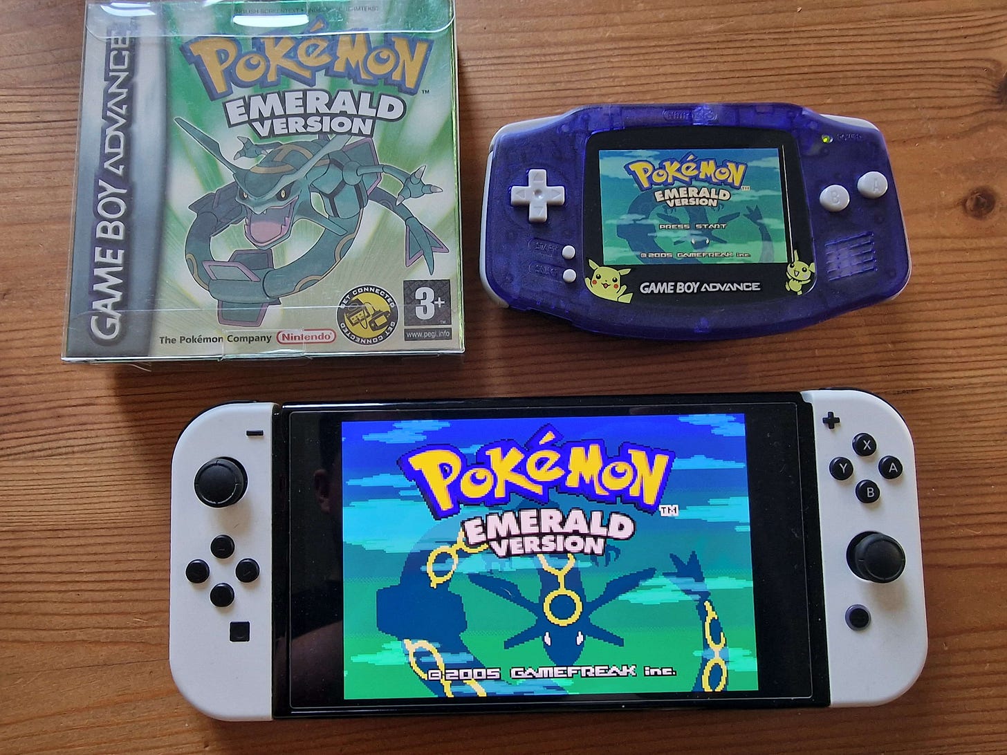 Fangking Omega’s Nintendo Switch OLED, running a copy of Pokémon Emerald, alongside his legitimate copy of Pokémon Emerald on Game Boy Advance. Maybe someday a release on Switch will be possible via official means?