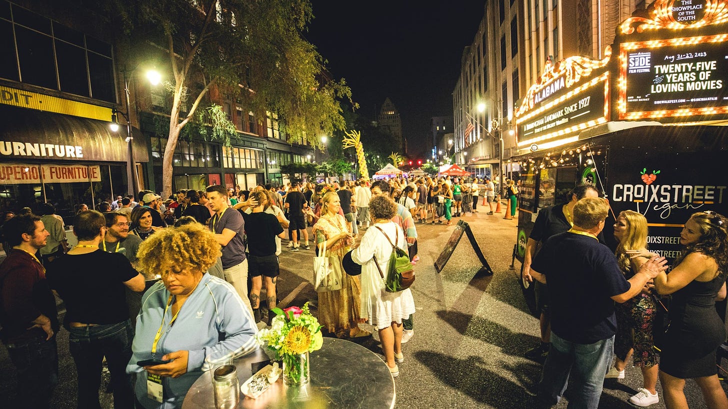 May be an image of 4 people, crowd and street