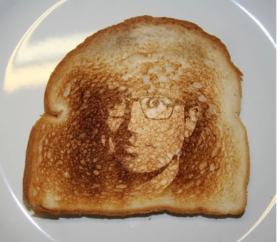 a piece of toast with John Oliver's face on it