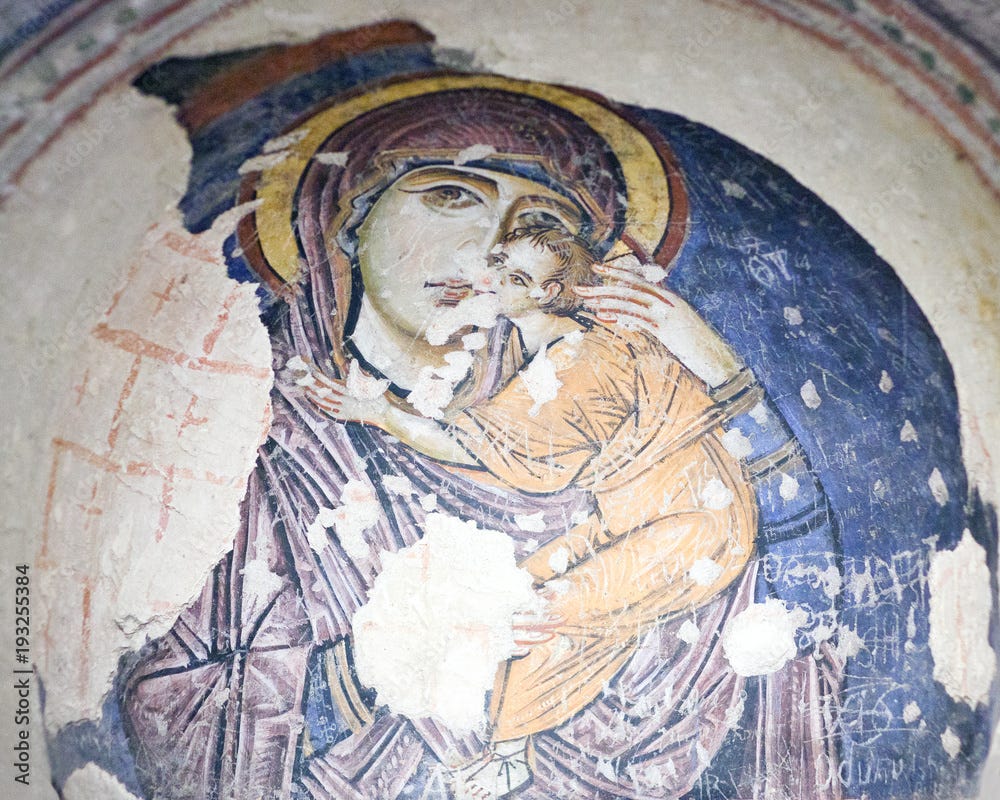 Fractured image of an old icon of Mary with wide eyes, holding the Christ child