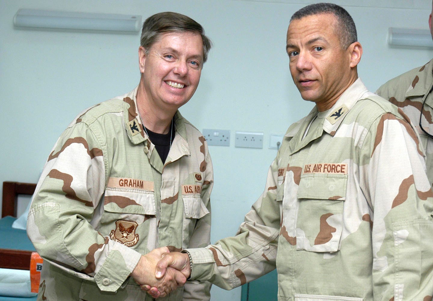 Col. Lindsey Graham, a senior Senator from South Carolina, is presented a 386th Expeditionary Medical Group coin by Col. Andrew Montiero in the Contingency Air Medical Staging Facility on the Rock on April 9.