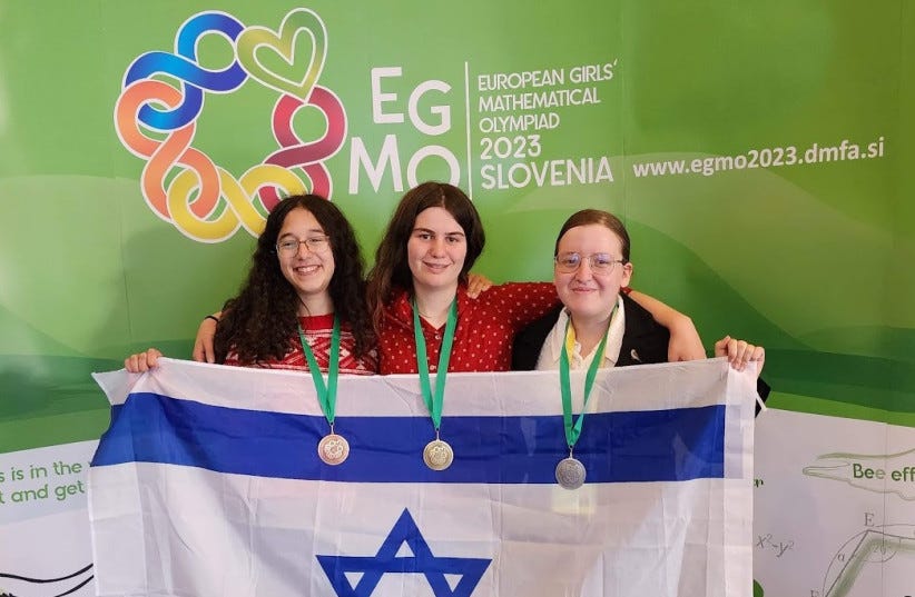 israeli girls who just won a math competition holding an israeli flag
