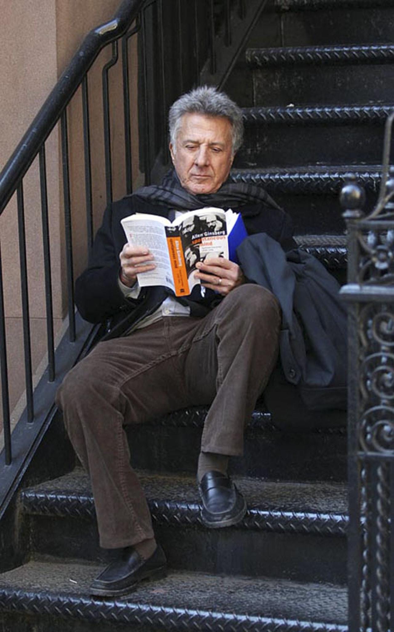 Dustin Hoffman poses with a book of Allen Ginsberg's essays, "Spontaneous Mind."