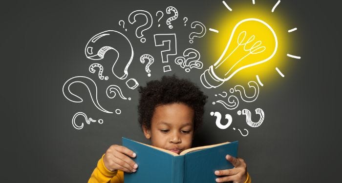 Image of a young Black boy reading a book