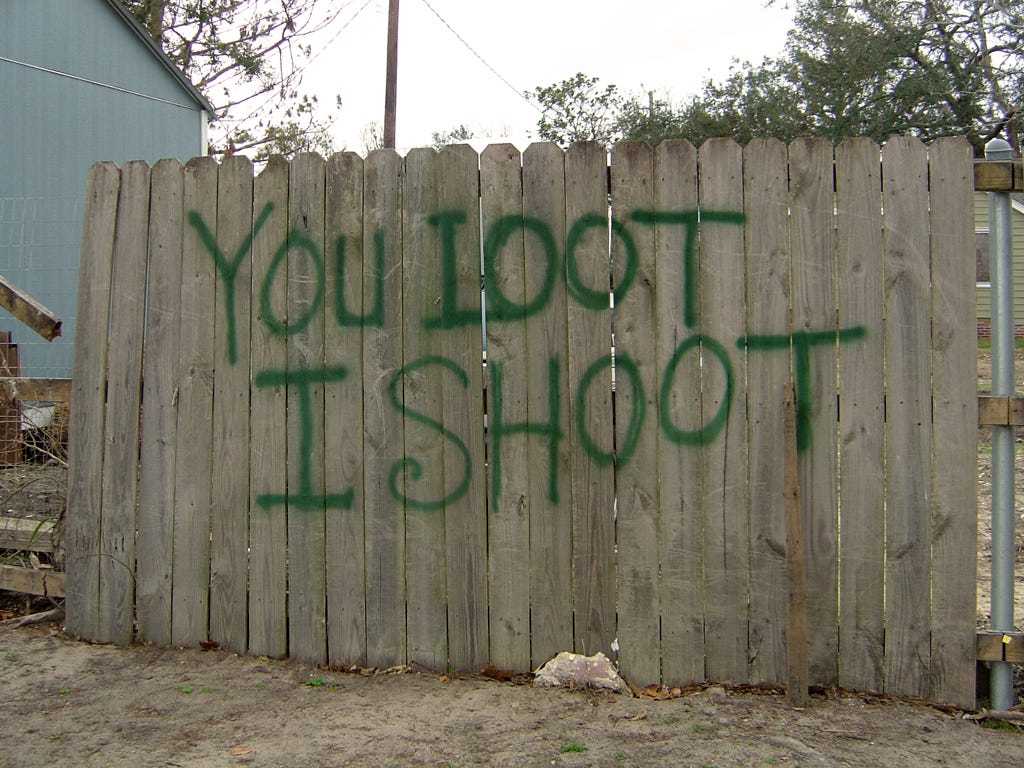 Sign painted on wooden fence in Biloxi, Mississippi after Hurricane Katrina: "You loot. I Shoot" You Loot, I Shoot