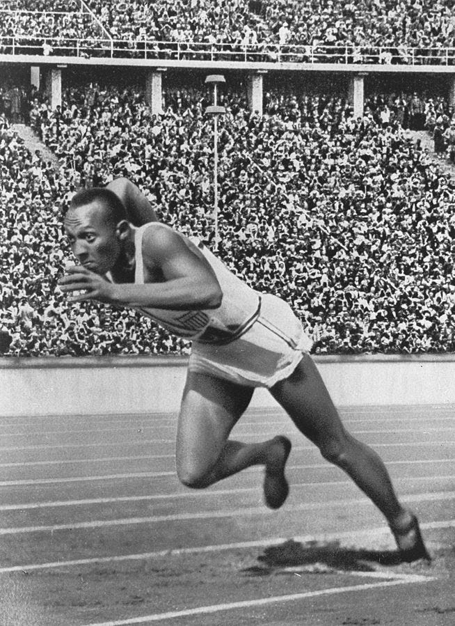 Picture of Jesse Owens sprinting down the track at the Olympics.