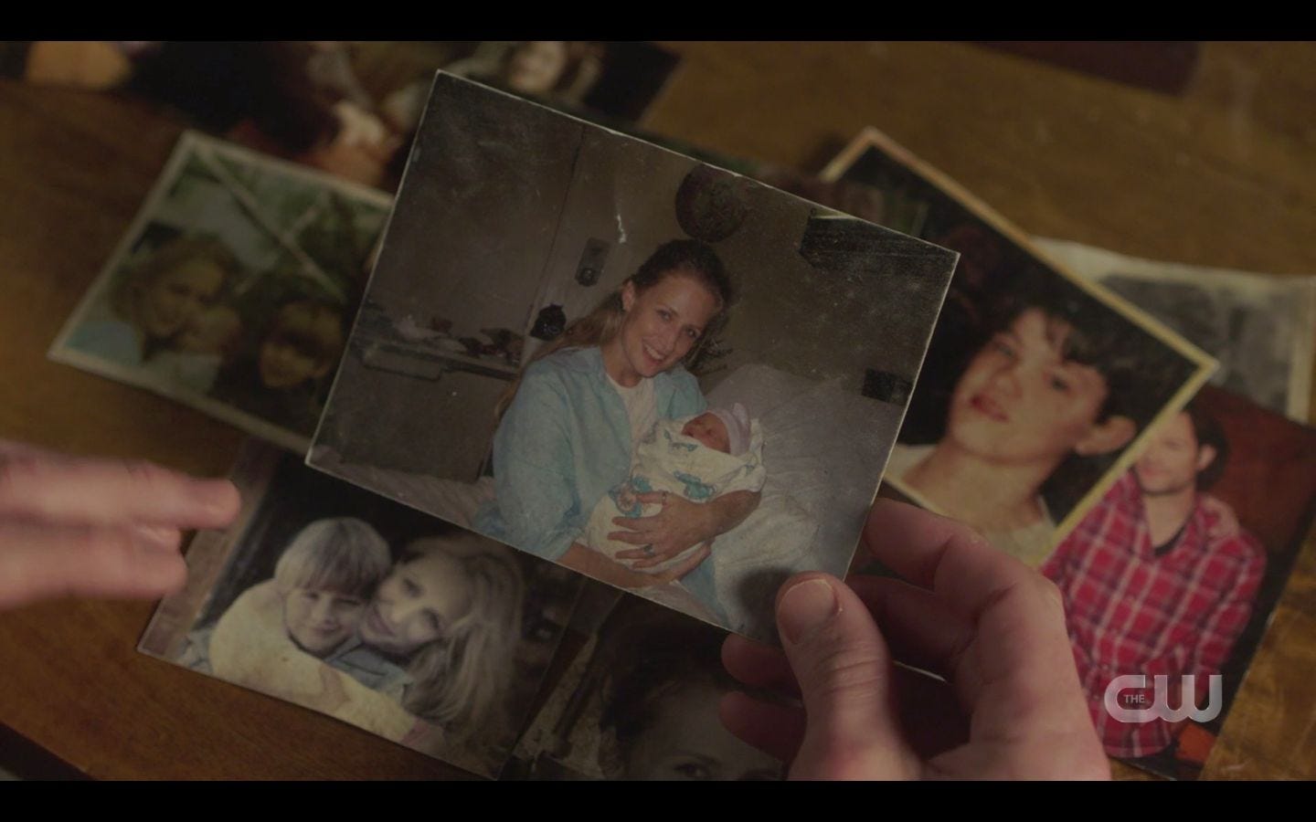 Sam WInchesters with photos of baby Sam and Dean SPN Absence