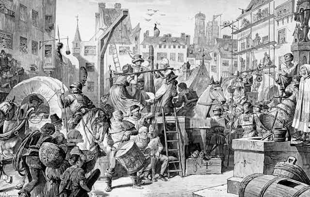 A historical black and white illustration featuring a bustling town square with soldiers, wagons and in the centre two women with stocks around their necks on a raised platform.