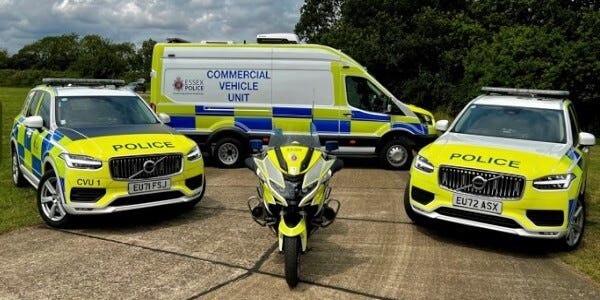 Commercial Vehicle Unit - two police cars, a police motorcycle and a police van.