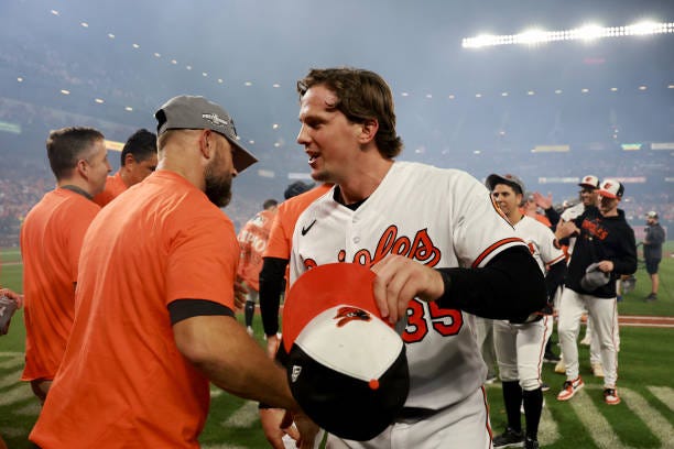 Adley Rutschman of the Baltimore Orioles celebrates after the Orioles defeate the Boston Red Sox to win the American League East at Oriole Park at...