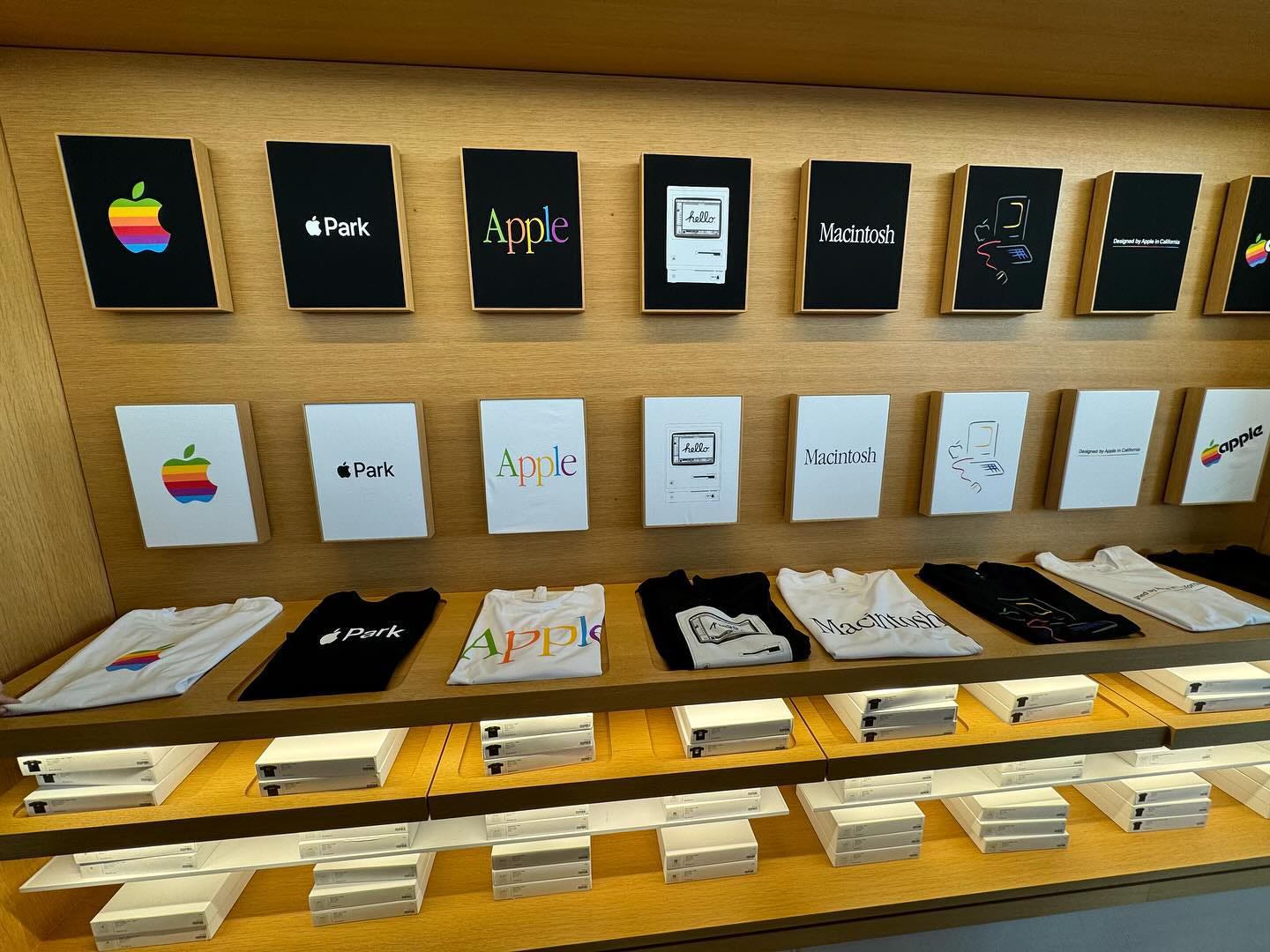 The t-shirt bay at Apple Park Visitor Center. Shirts are offered in white and black across a variety of designs.