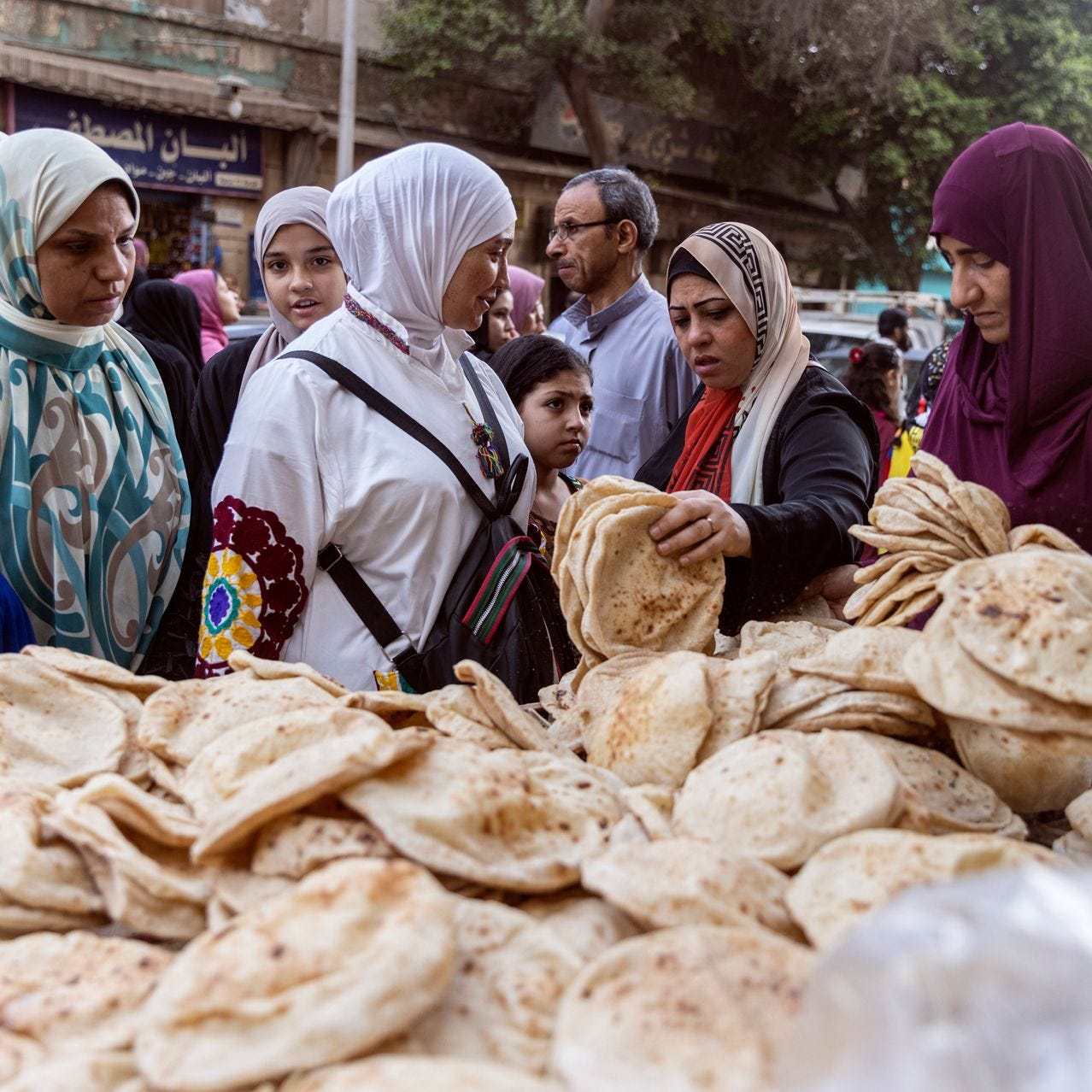 Women buy bread from a local stand in Cairo, Egypt, May 2022.