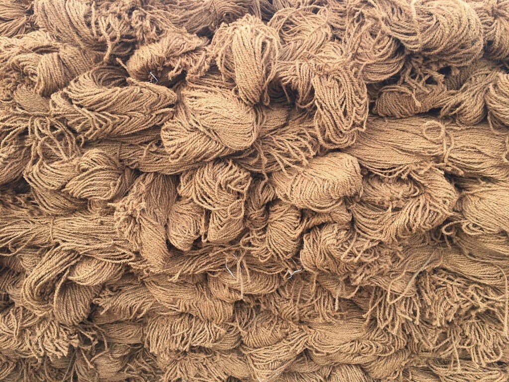A pile of brown yarn

Description automatically generated
