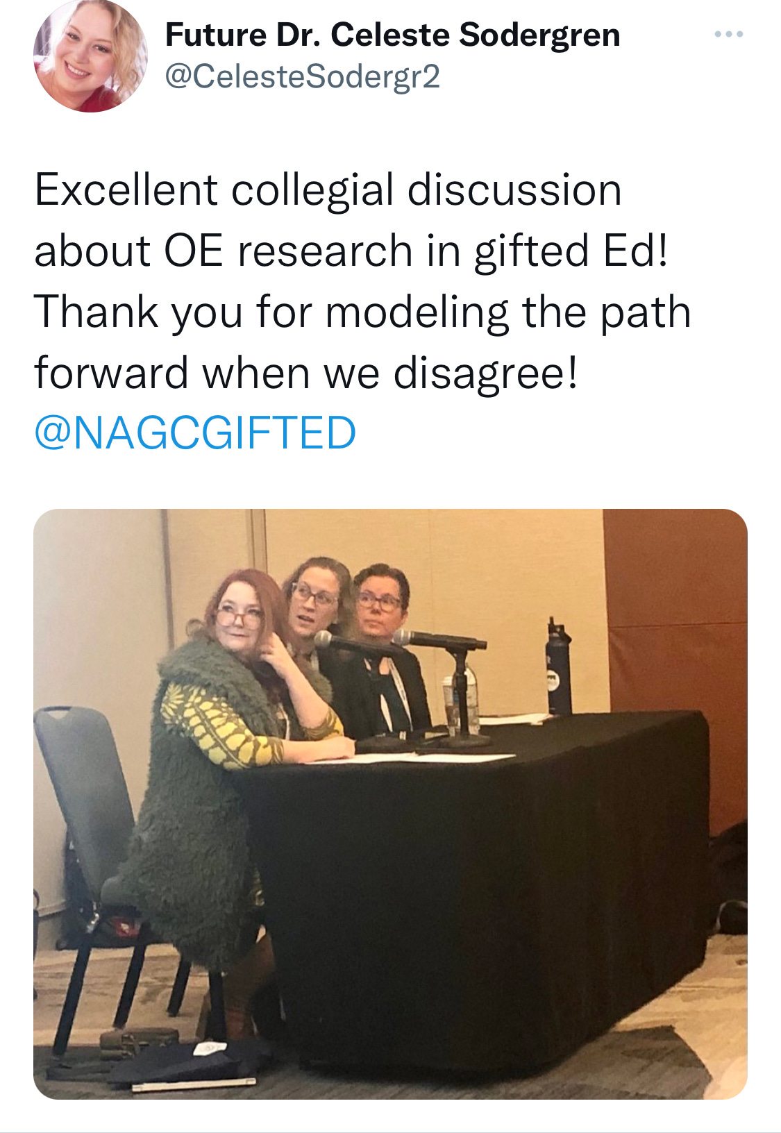 Image description: tweet from Celeste Sodergren, "Excellent collegial discussion about OE research in Gifted Ed! Thank you for modeling the path forward when we disagree! @NAGCGIFTED." Photo of Erin, Anne, and Chris looking at a slide off screen. 