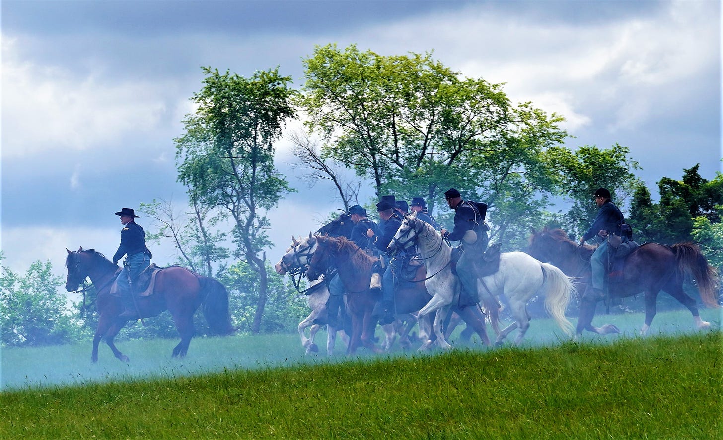 horses and riders head to the battlefield in a smoky haze