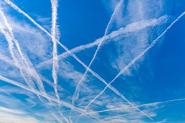 Contrails Contrails over blue sky. chemtrail stock pictures, royalty-free photos & images