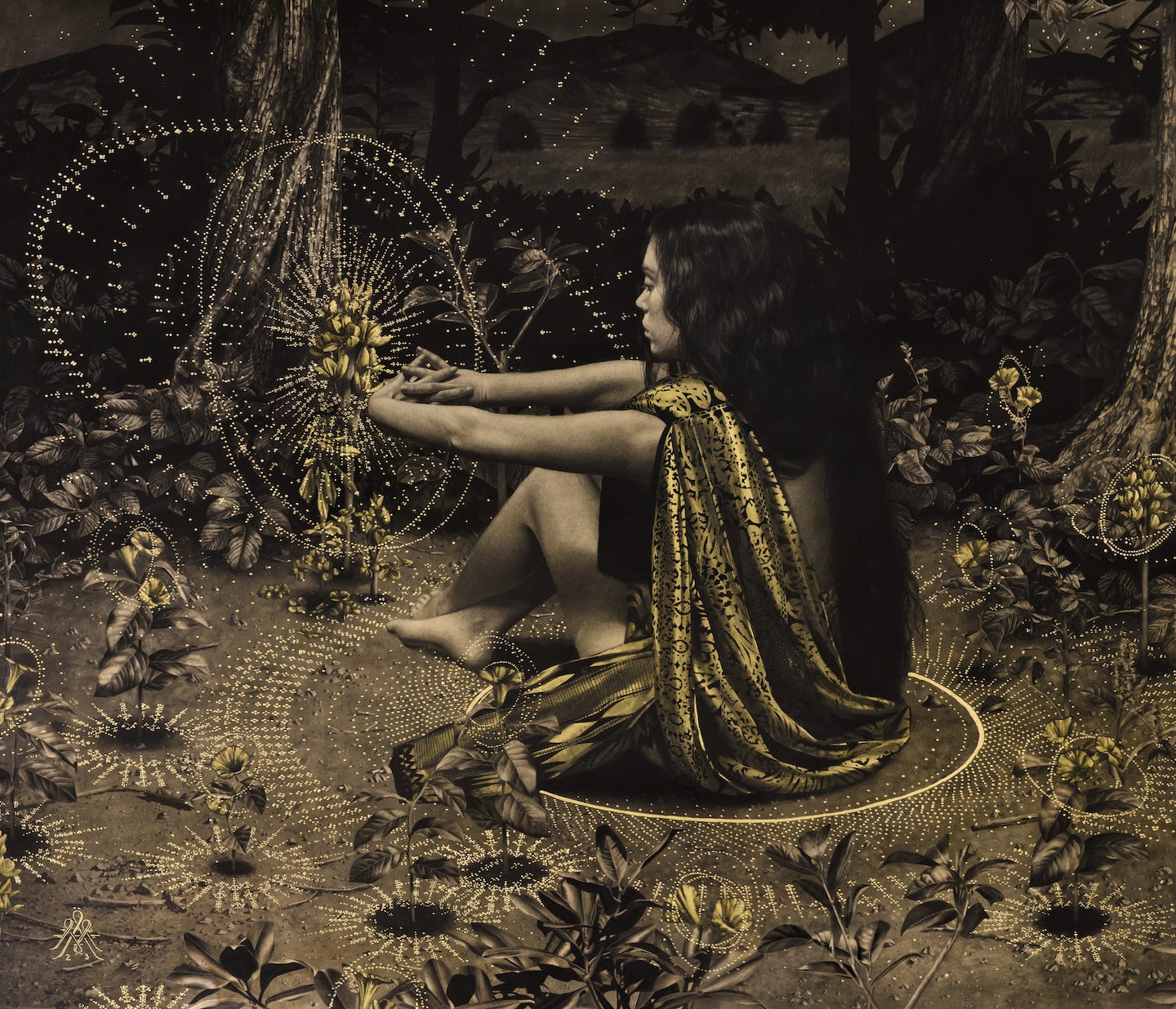 A woman sits with a golden fabric strone across her body and has gold circular deisgns in the air and all around her. She is in a forest with trees and flowers around her as well. 