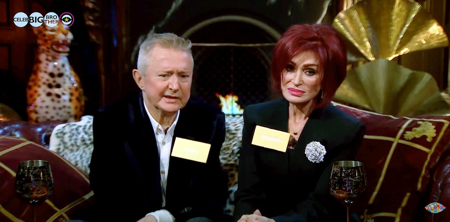 Sharon Osbourne and Louis Walsh in the secret lair of Celebrity Big Brother, looking a little disappointed and disgusted with whatever they're looking at