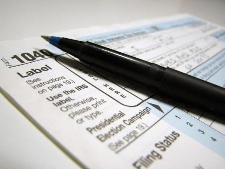 Free Stock Photo of Closeup of a 1040 tax form and a pen