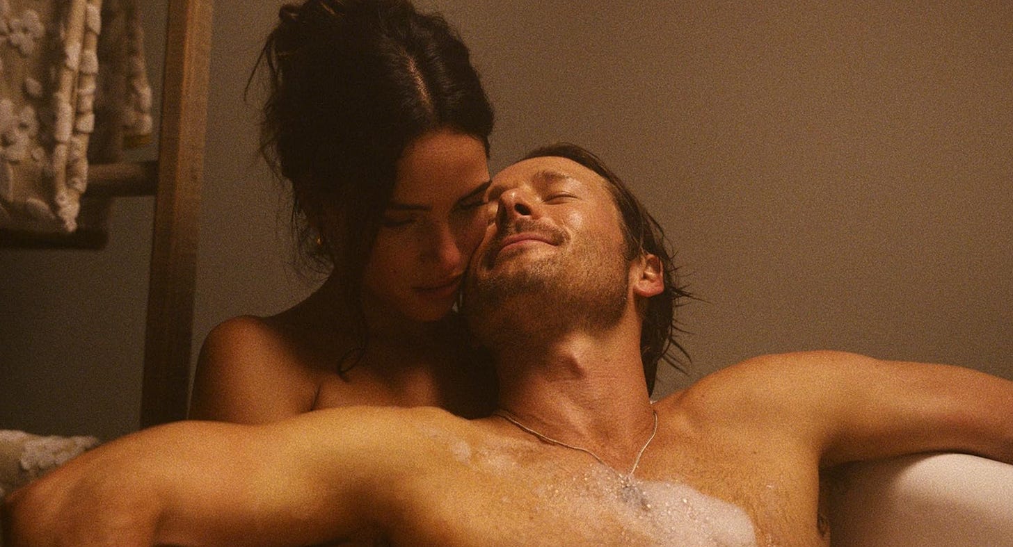 Glen Powell and Adria Arjona in the bath in "Hit Man" (2024)