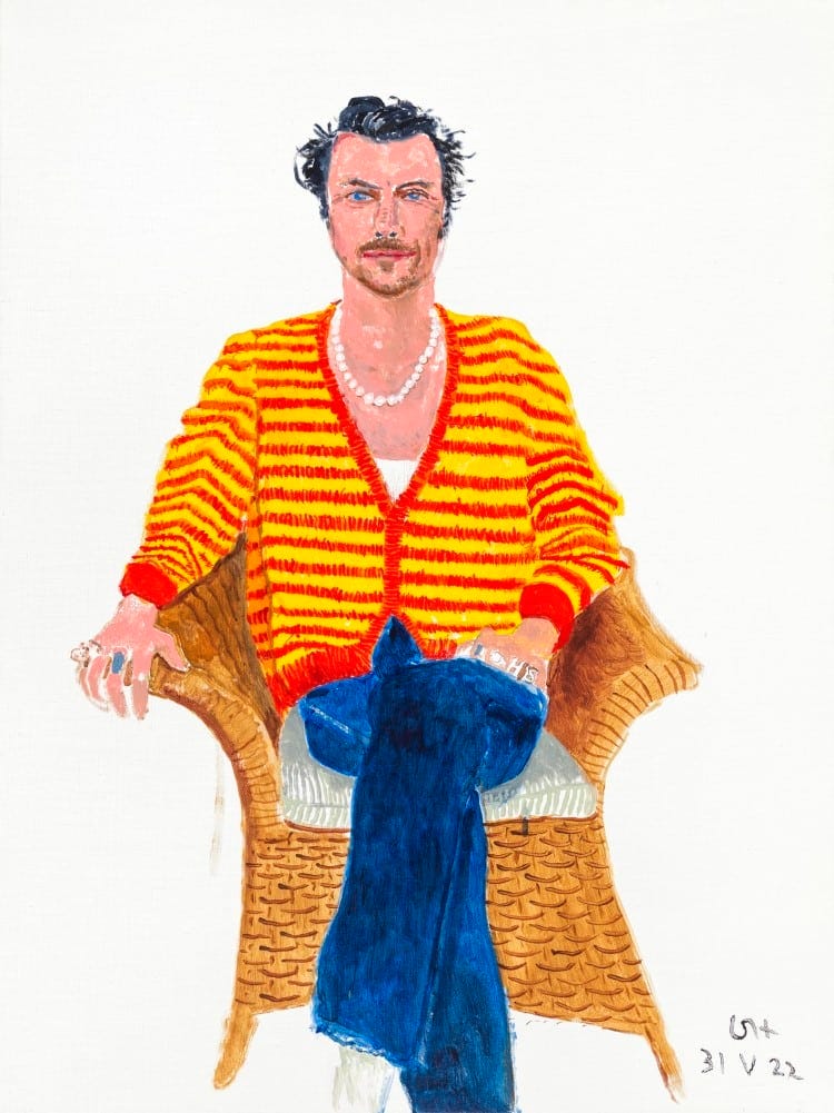 portrait of Harry Styles wearing a yellow and red striped cardigan