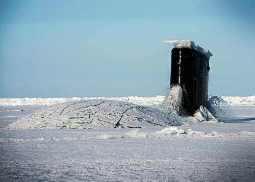 A U.S. Navy nuclear-powered submarine breaks out of the icy sea