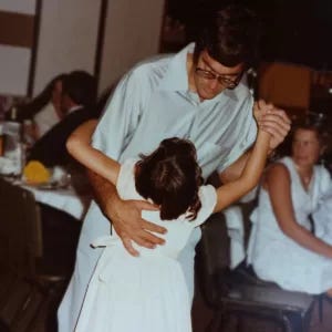 the author dancing with her father when she was very young