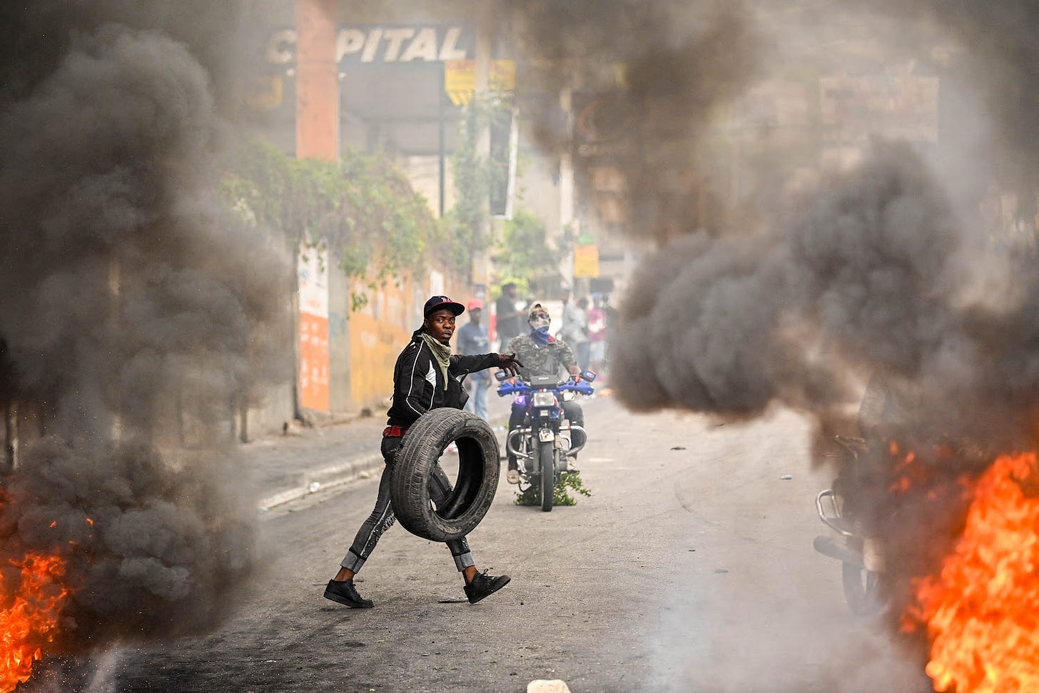 A protester burns tires during a demonstration calling for the resignation of acting Prime Minister Ariel Henry in Port-au-Prince.