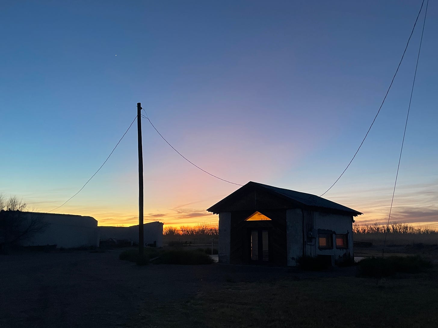 A studio at Sonic Ranch in the foreground, a gorgeous yellow sunset in the background