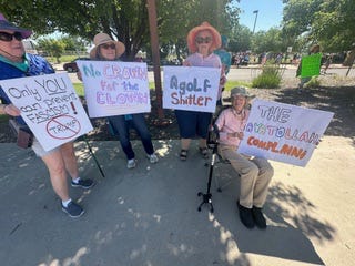 A group of people holding signs

AI-generated content may be incorrect.