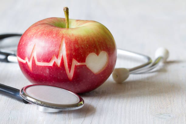 heartbeat line on red apple and stethoscope, healthy heart diet concept - diet bildbanksfoton och bilder