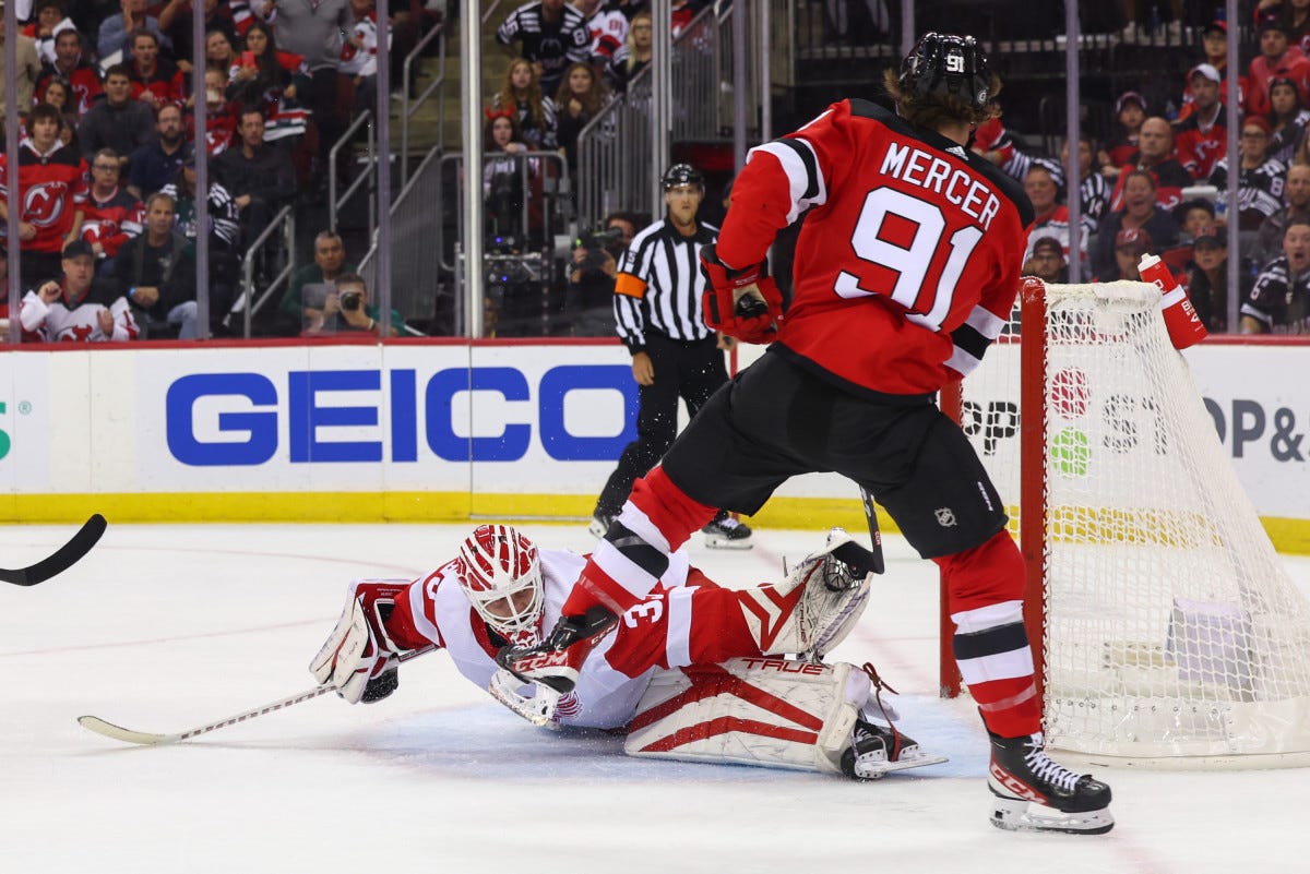 Oct 12, 2023; Newark, New Jersey, USA; Detroit Red Wings goaltender Ville Husso (35) makes a save on New Jersey Devils center Dawson Mercer (91) during the second period at Prudential Center. Mandatory Credit: Ed Mulholland-USA TODAY Sports