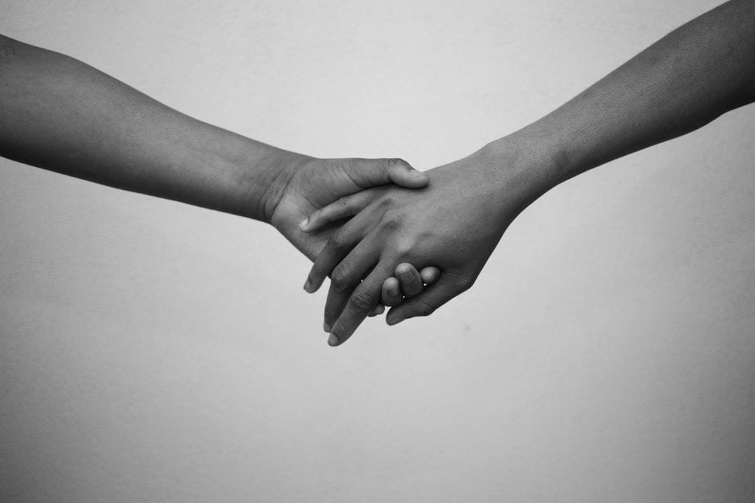 persons hand on white surface persons hand on white surface