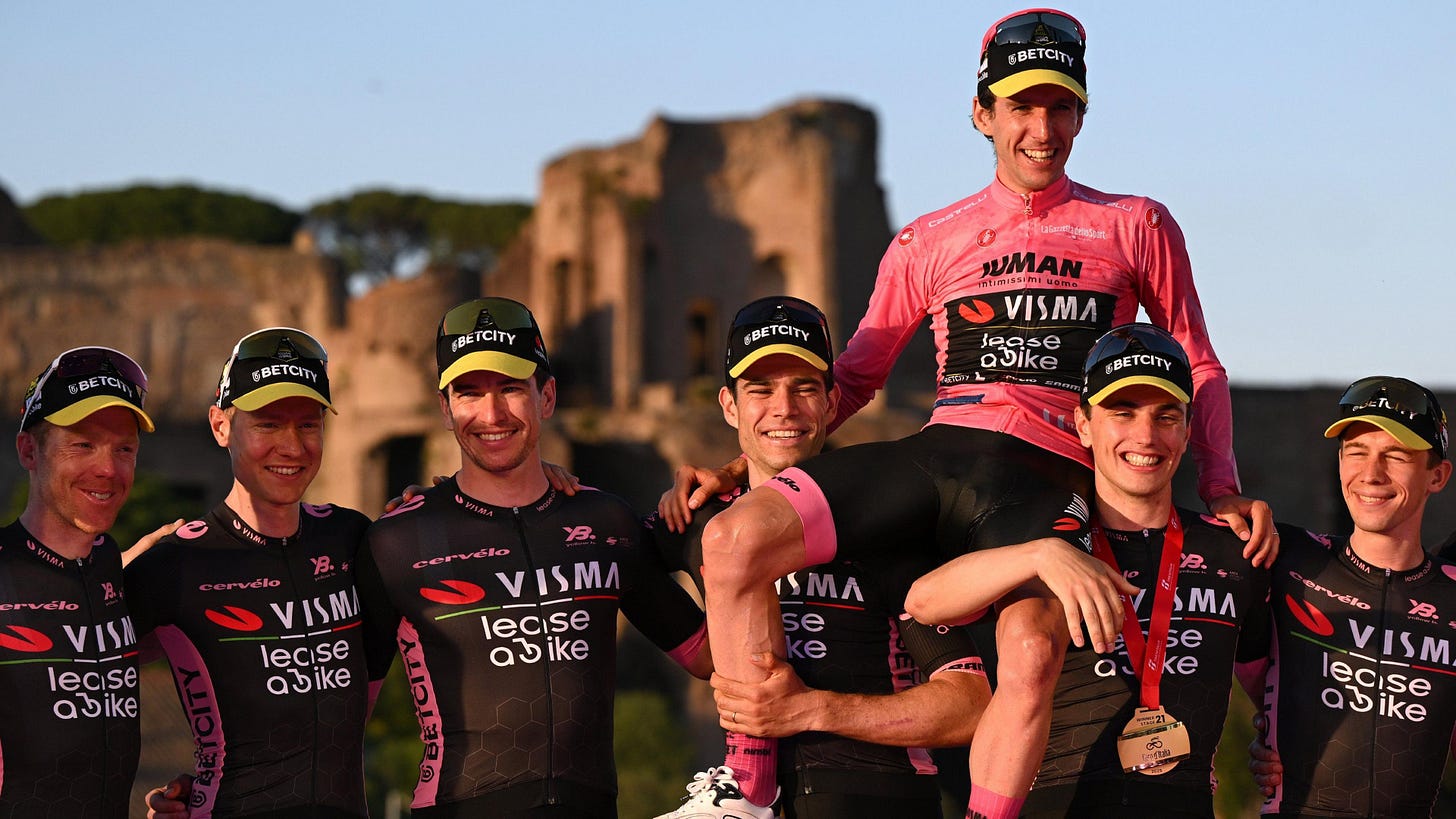 Simon Yates, wearing the pink jersey as the winner of the 2025 Giro d'Italia, sits on the shoulders of his Visma-Lease a Bike team-mates on the podium Simon Yates, wearing the pink jersey as the winner of the 2025 Giro d'Italia, sits on the shoulders of his Visma-Lease a Bike team-mates on the podium