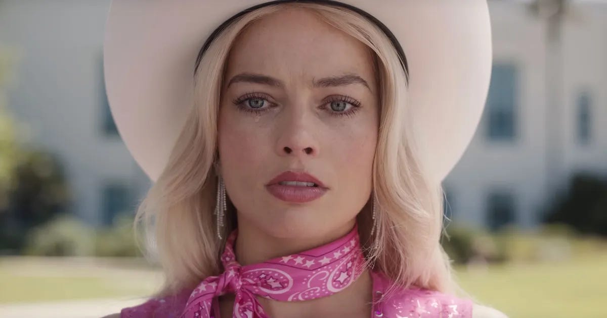 Close up of Margot Robbie in Barbie with a tear in her eye.