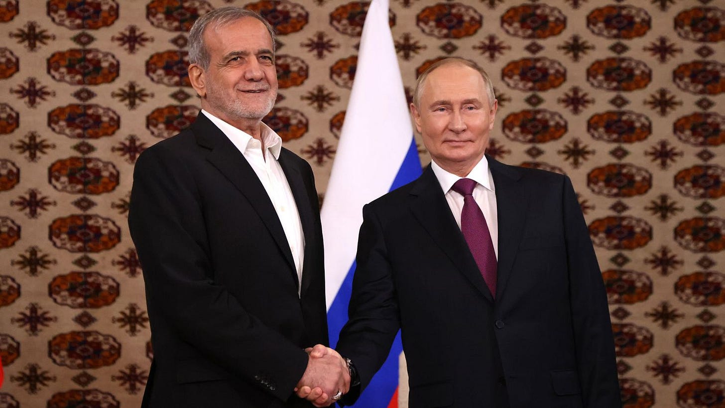 Putin and Pezeshkian shake hands during their first meeting, held Friday in Ashgabat, Turkmenistan.