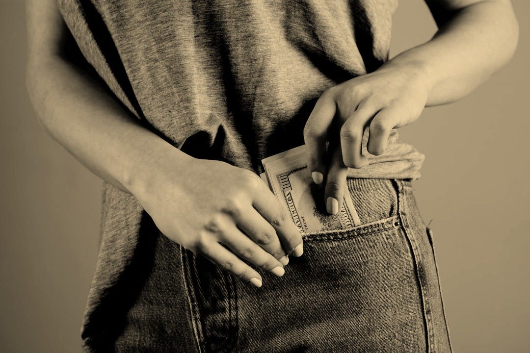 person in gray shirt and blue denim jeans holding blue denim jeans person in gray shirt and blue denim jeans holding blue denim jeans